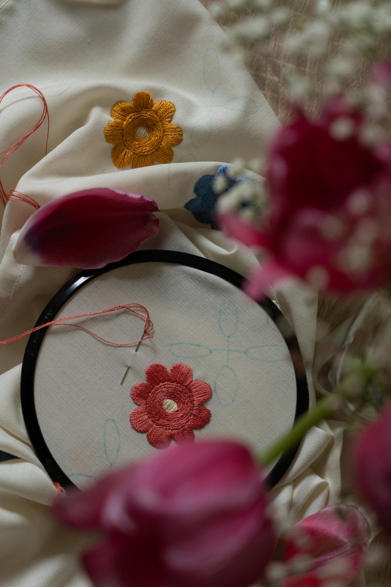 close-up of hand-stitched floral embroidery on linen